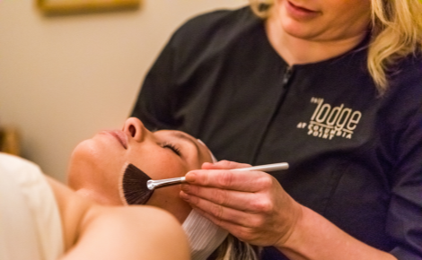 Two people in a spa receiving a facial 