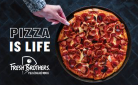 Overhead view of a pepperoni pizza on a dark tabletop. A hand reaches toward a slice near the top of the pizza. Large white text reads “Pizza Is Life,” and the Fresh Brothers Pizza Salad Wings logo appears below the text.