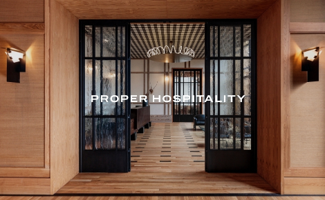 Hallway with wood accents and black framed glass doors at Austin Proper