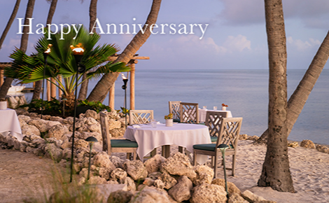 eGift card image of a table set up for dining on the beach and the text 