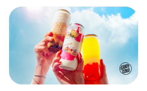 Three candy cloud drinks being held to blue sky