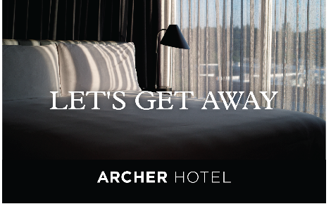 Bed with sun coming through curtains with "Let's Get Away" message