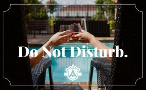 eGift card image of a couple by the pool clinking glasses with the Ambassador Hotel Oklahoma City logo