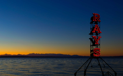 Ray's iconic red neon sign with Puget Sound and the Olympic Mountains.