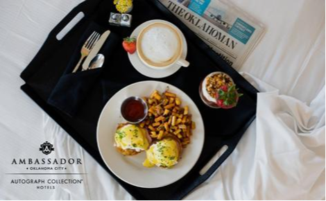 eGift card image of breakfast in bed and the Ambassador Hotel Oklahoma City logo