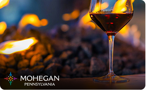 eGift card image of the fire pit and a glass of red wine with the Mohegan Pennsylvania logo