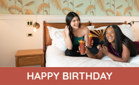eGift card image of two girls drinking cocktails in a suite with the text 