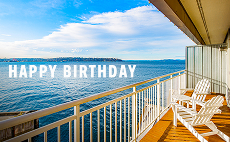 Gift card image if the view across the water from a hotel room balcony with the text “Happy Birthday”