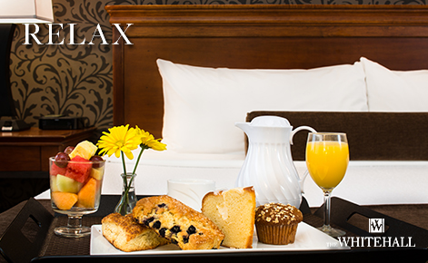 eGift Card image of hotel room and room service food with the text “Relax” and The Whitehall logo