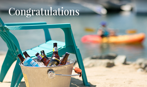 Gift card image of a chair and bucket of beers on the beach with the text 