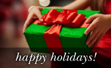 Image of a gift wrapped present in green with the red ribbon and the text 