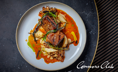 Gift card image of food with the Commons Club logo