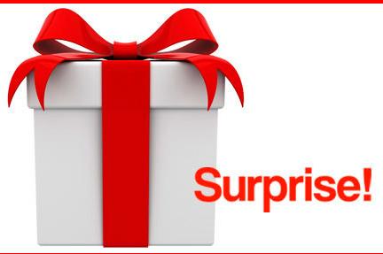 Image of a white gift with red ribbon with the text 