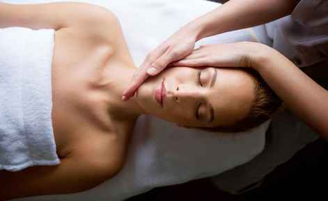 Image of lady receiving a head massage