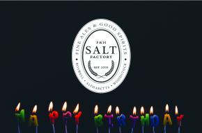 Image of lit candles with the Salt Factory logo