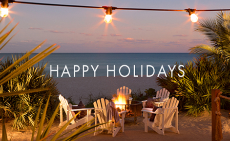 Gift card image of seating on the beach at sunset with the text “Happy Holidays” 