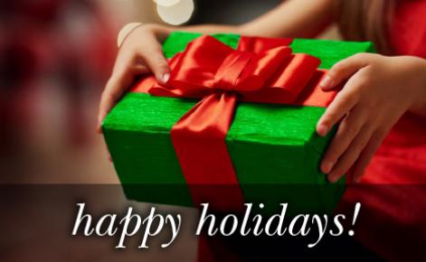 mage of a gift wrapped present in green with the red ribbon and the text 
