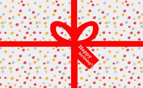 Image of a polka dot wrapped gift with red ribbon
