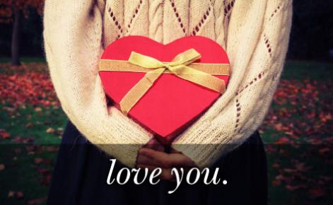 Image of a red gift in the shape of a heart with the text 