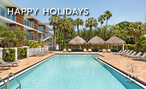 eGift Card image of swimming pool on a sunny day with the text “Happy Holidays” and the Hotel Alba logo