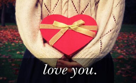 Image of a red gift in the shape of a heart with the text 