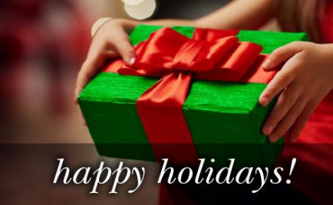 Image of a gift wrapped present in green with the red ribbon and the text 