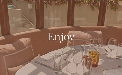Gift card image of booth and table in restaurant with the text “Enjoy”