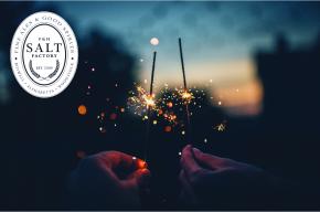 Night time skyline image with the Salt Factory logo