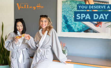 two women with cocktails in VH Spa lobby; text says "You Deserve a Spa Day"