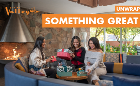 three women unwrapping gifts in hotel lobby; text says "Unwrap Something Great"