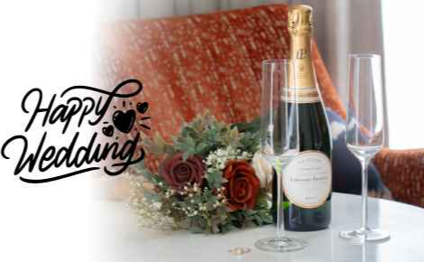 An image of a wedding bouquet, wedding rings, a bottle of champagne, and two champagne flutes in the Arbor Suite, with the words "Happy Wedding"