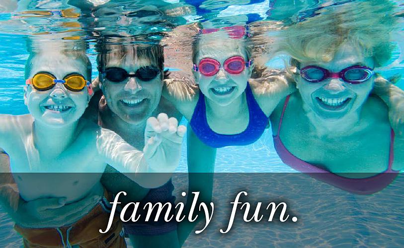 Image of a family in the pool under water looking at the camera with the text 