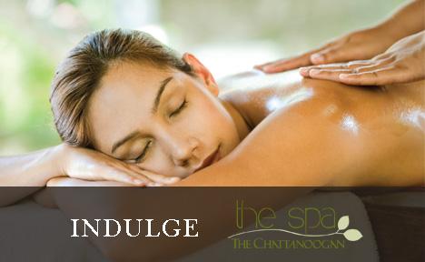 Image of lady receiving a massage with the text 'Indulge