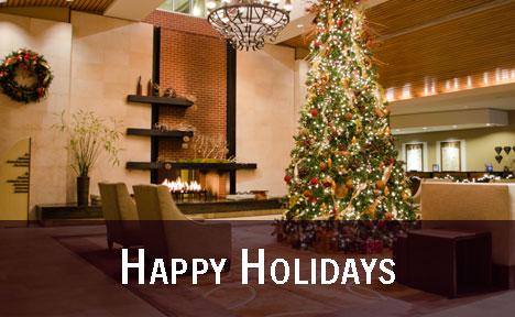 Internal image of reception with Christmas tree with the text 'Happy Holidays