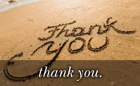 Image of Thank You written in the sand with the text 