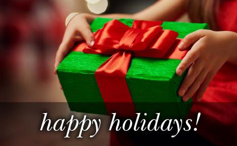 Image of a green present with red ribbon with the text 