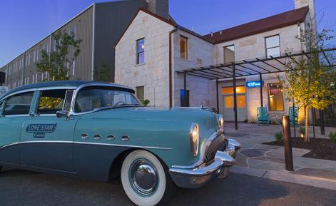 External image of hotel with vintage car in forefront