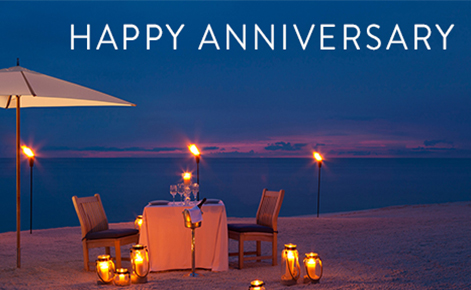 Gift card image of a table on the beach at sunset with the text 