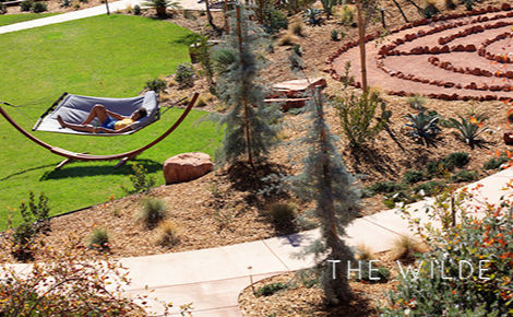 eGift card image of a guest relaxing in a hammock with the Wilde Resort & Spa logo