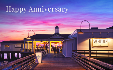 eGift card image of the Wharf restaurant at sunset with the text “Happy Anniversary” 