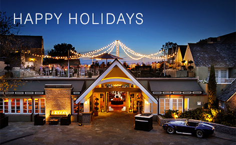 Gift card image of the front of the hotel at night with the text “Happy Holidays”