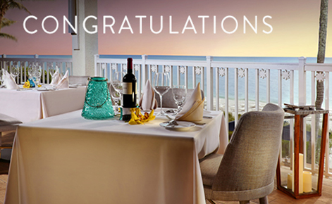 Gift card image of table overlooking the sea from the balcony with the text 