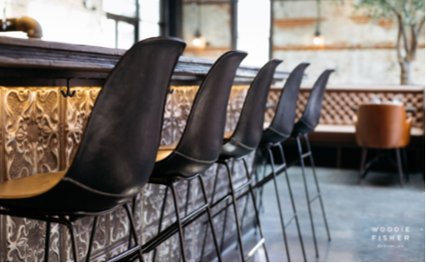 eGift card image of the chairs along the bar with the Woodie Fisher Kitchen & Bar logo