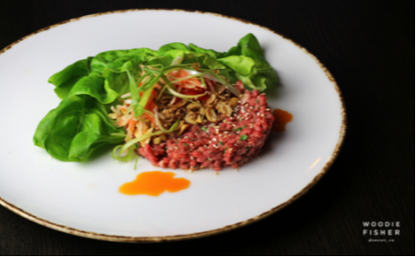 eGift card image of the Thai Beef with the Woodie Fisher Kitchen & Bar logo
