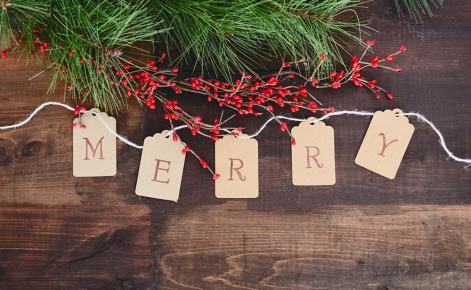M-E-R-R-Y spelled out on paper cards on a string for Christmas