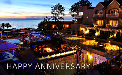 Gift card image of the exterior of the hotel at night with the text “Happy Anniversary”