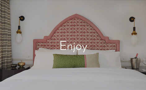 Gift card image of hotel room bed with the text “Enjoy”