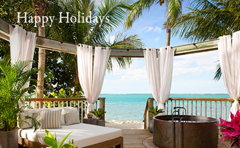 Gift card image of seating area overlooking the ocean with the text “Happy Holidays” 