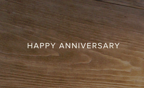 Gift card image with the text “Happy Anniversary” on a wood texture background