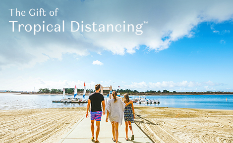 Gift card image of a family walking along the beach with the text 